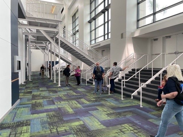 A group of people are walking down stairs in a building.