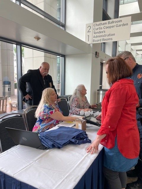A group of people are standing around a table in a room.