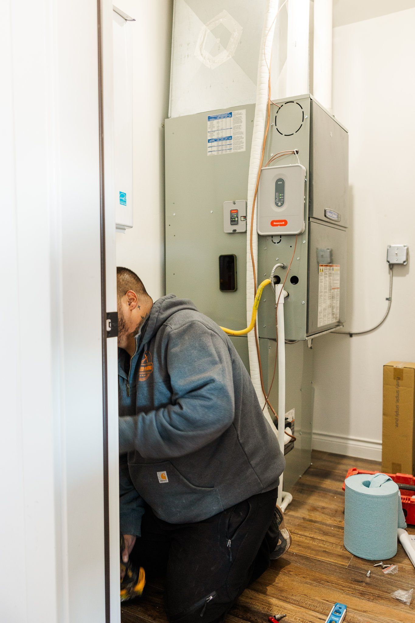 Jon working near furnace Unrivaled Plumbing & Heating Montrose CO