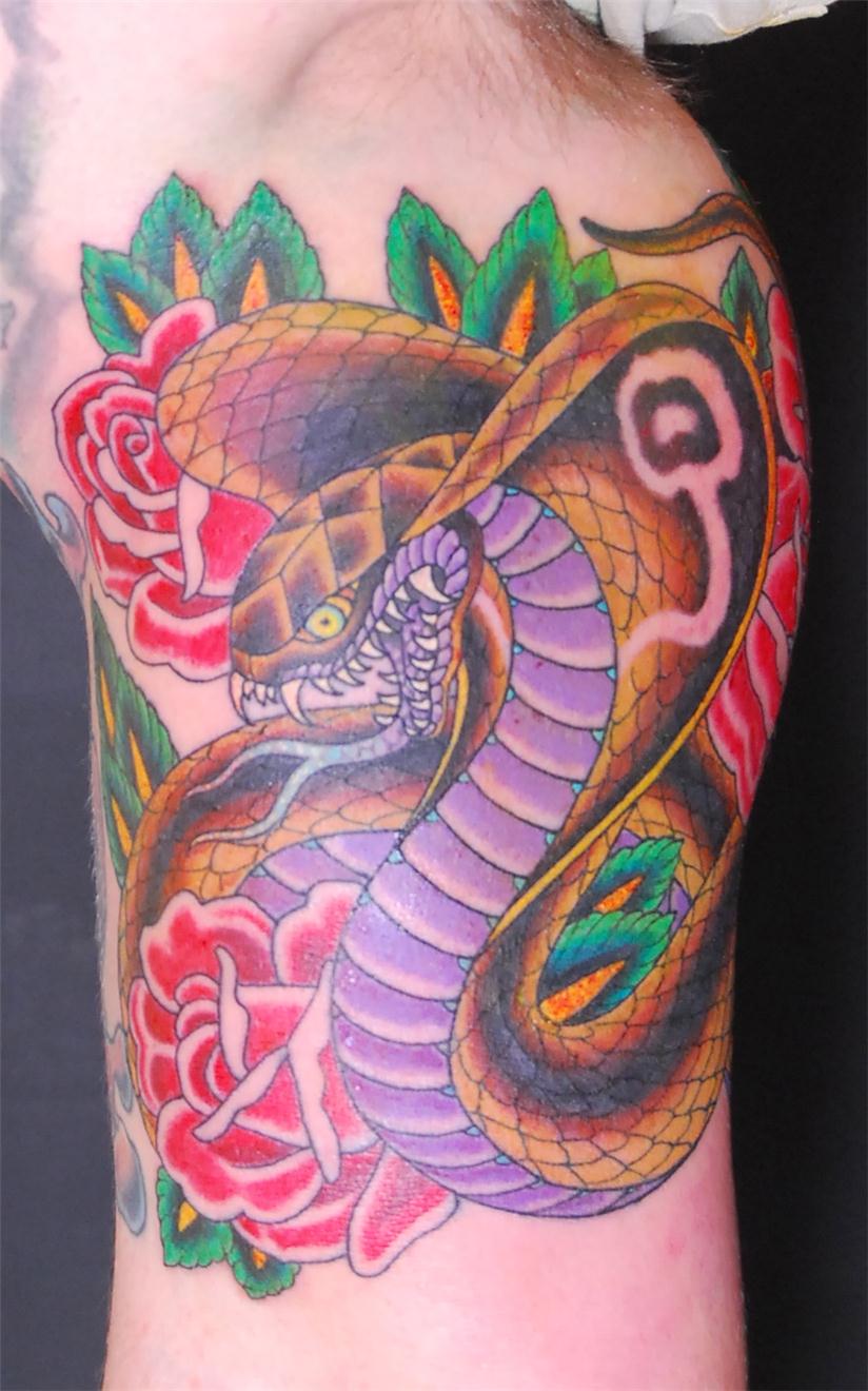 Cobra snake and flowers tattoo — Little Rock, AR — Seventh Street Tattoos & Piercing