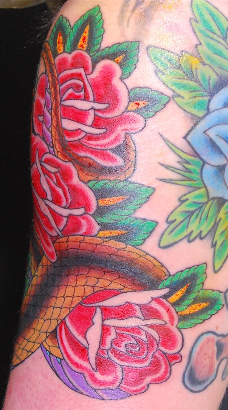Side view of cobra snake and flowers tattoo — Little Rock, AR — Seventh Street Tattoos & Piercing