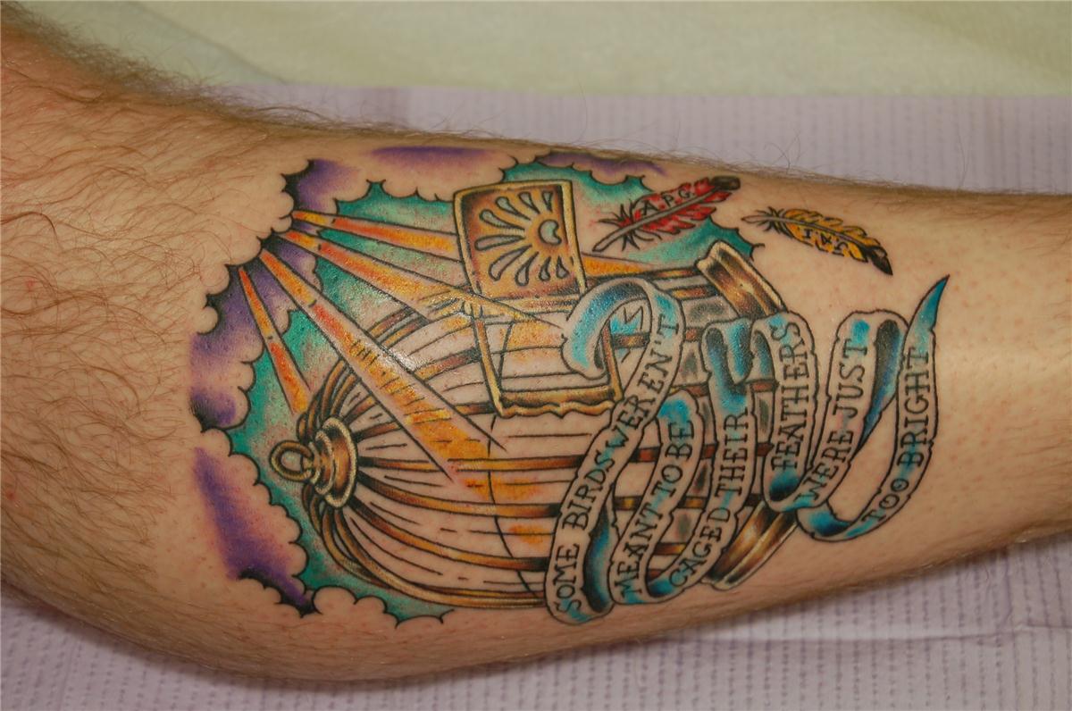 Golden bird cage and sky tattoo — Little Rock, AR — Seventh Street Tattoos & Piercing