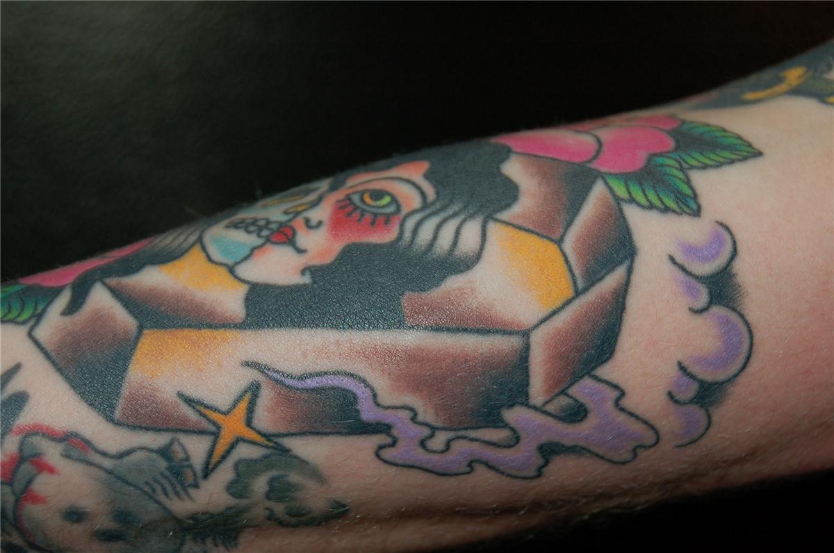 Half human and half undead face on top of coffin tattoo — Little Rock, AR — Seventh Street Tattoos & Piercing