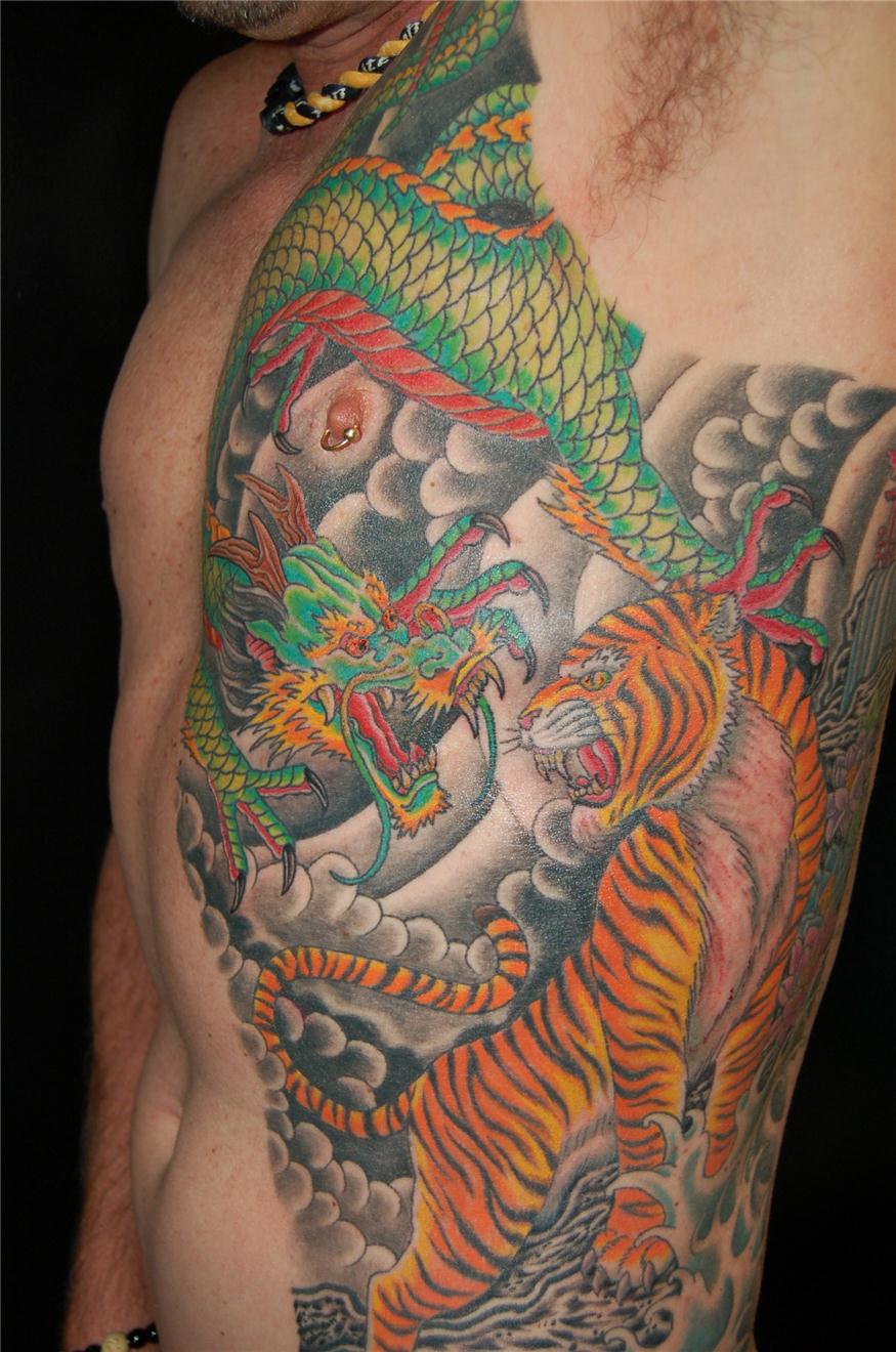 Dragon fighting tiger tattoo — Little Rock, AR — Seventh Street Tattoos & Piercing