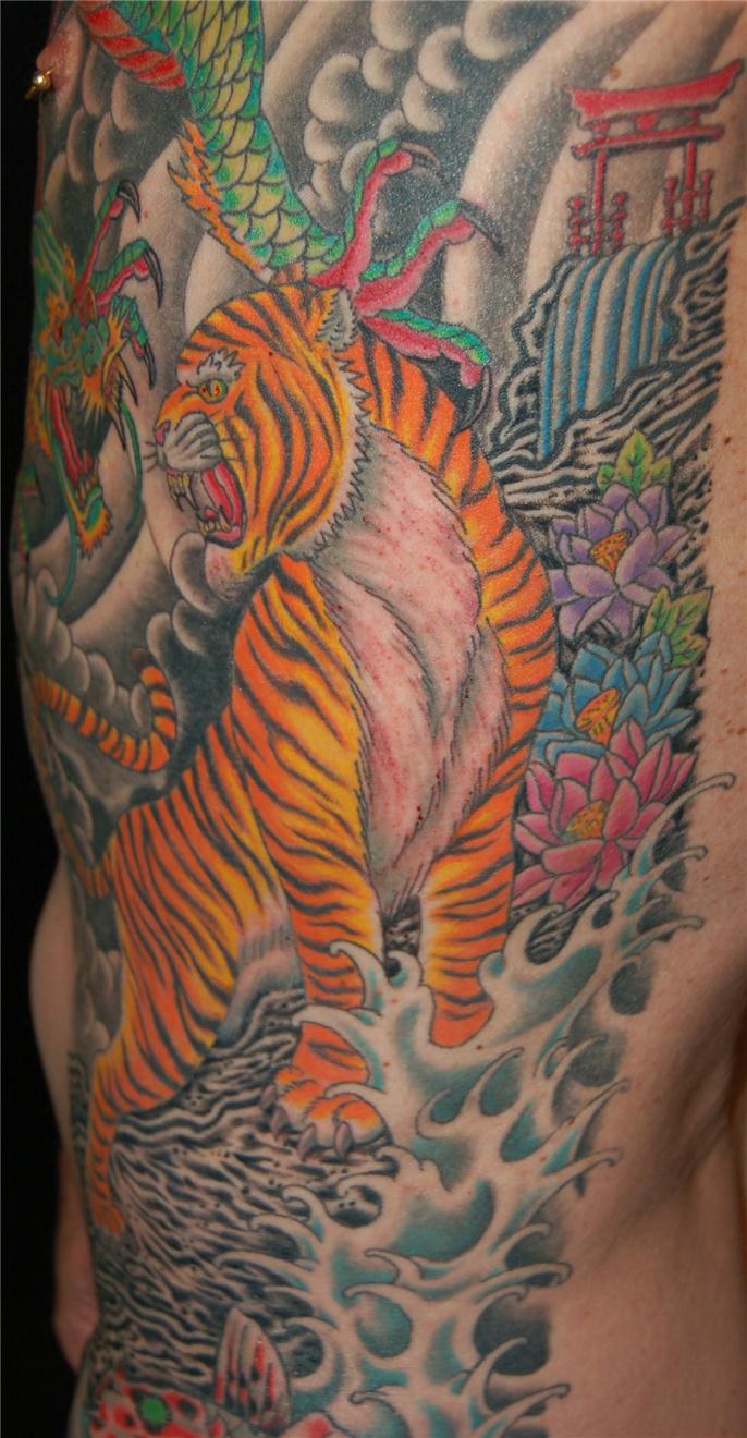 Other angle of dragon fighting tiger tattoo — Little Rock, AR — Seventh Street Tattoos & Piercing