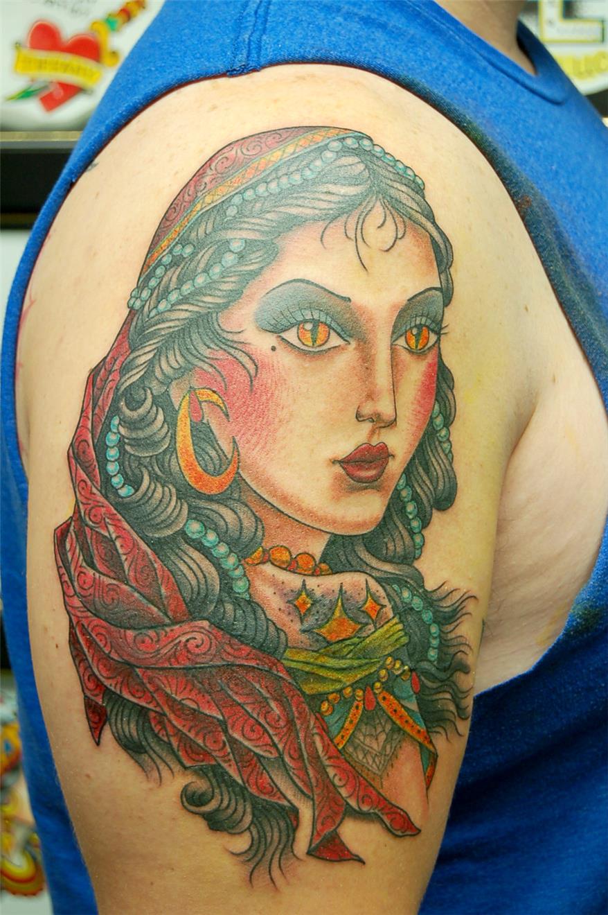 Woman with snake eyes tattoo — Little Rock, AR — Seventh Street Tattoos & Piercing