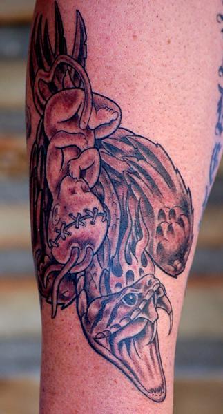 Baby with scarring on head sleeping with snake tattoo — Little Rock, AR — Seventh Street Tattoos & Piercing