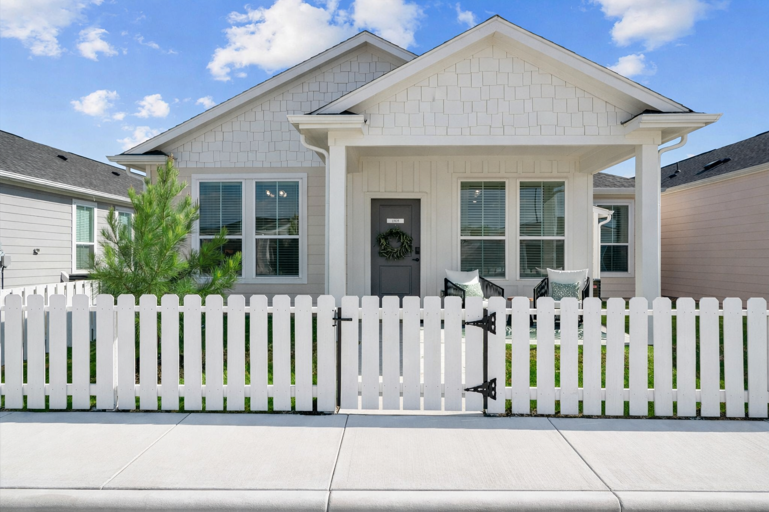 Bungalow  Cottage-style home with white fence in Baytown TX