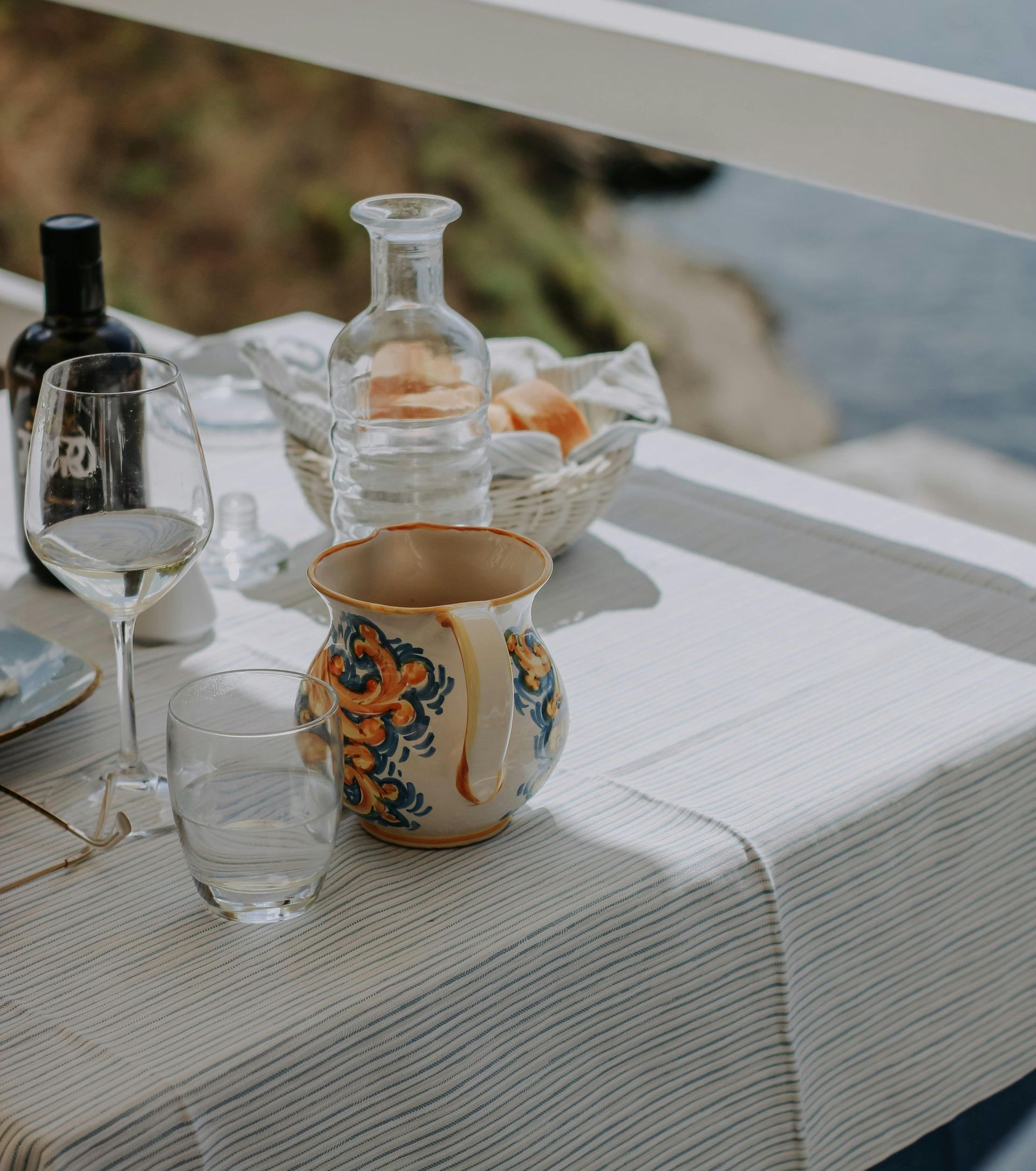 A table with a bottle of wine and glasses on it
