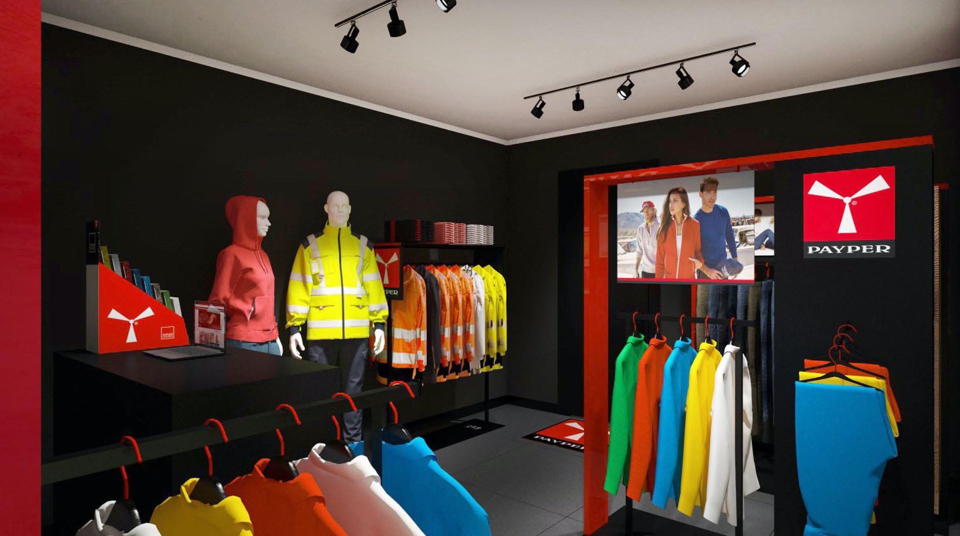 All'interno di un negozio, gli abiti da lavoro sono esposti su manichini e appendiabiti. Uno schermo mostra persone che indossano i capi del marchio.
