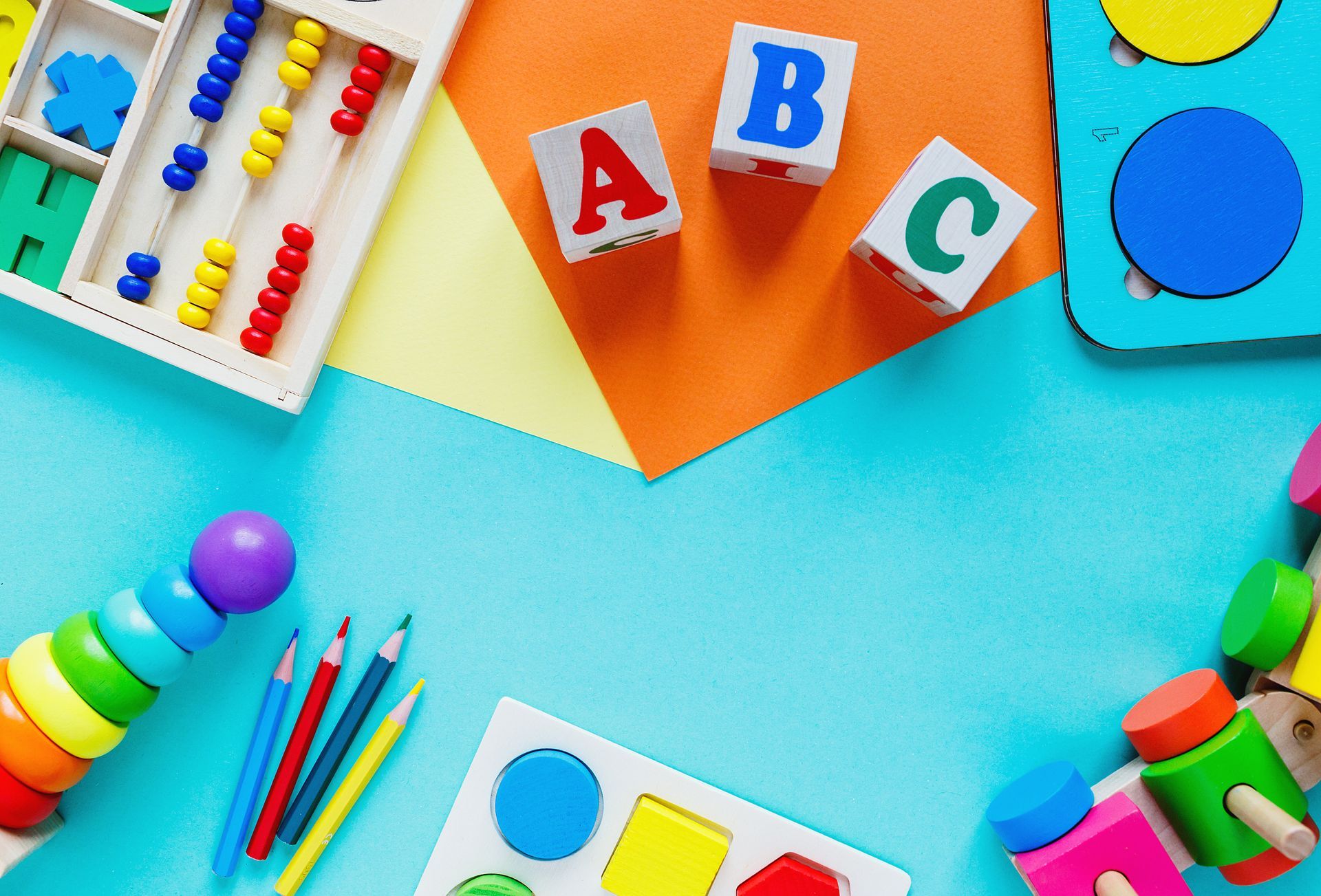 Wooden preschool toys showcasing colorful blocks, numbers, and learning tools on bright paper. Wooden preschool toys showcasing colorful blocks, numbers, and learning tools on bright paper.