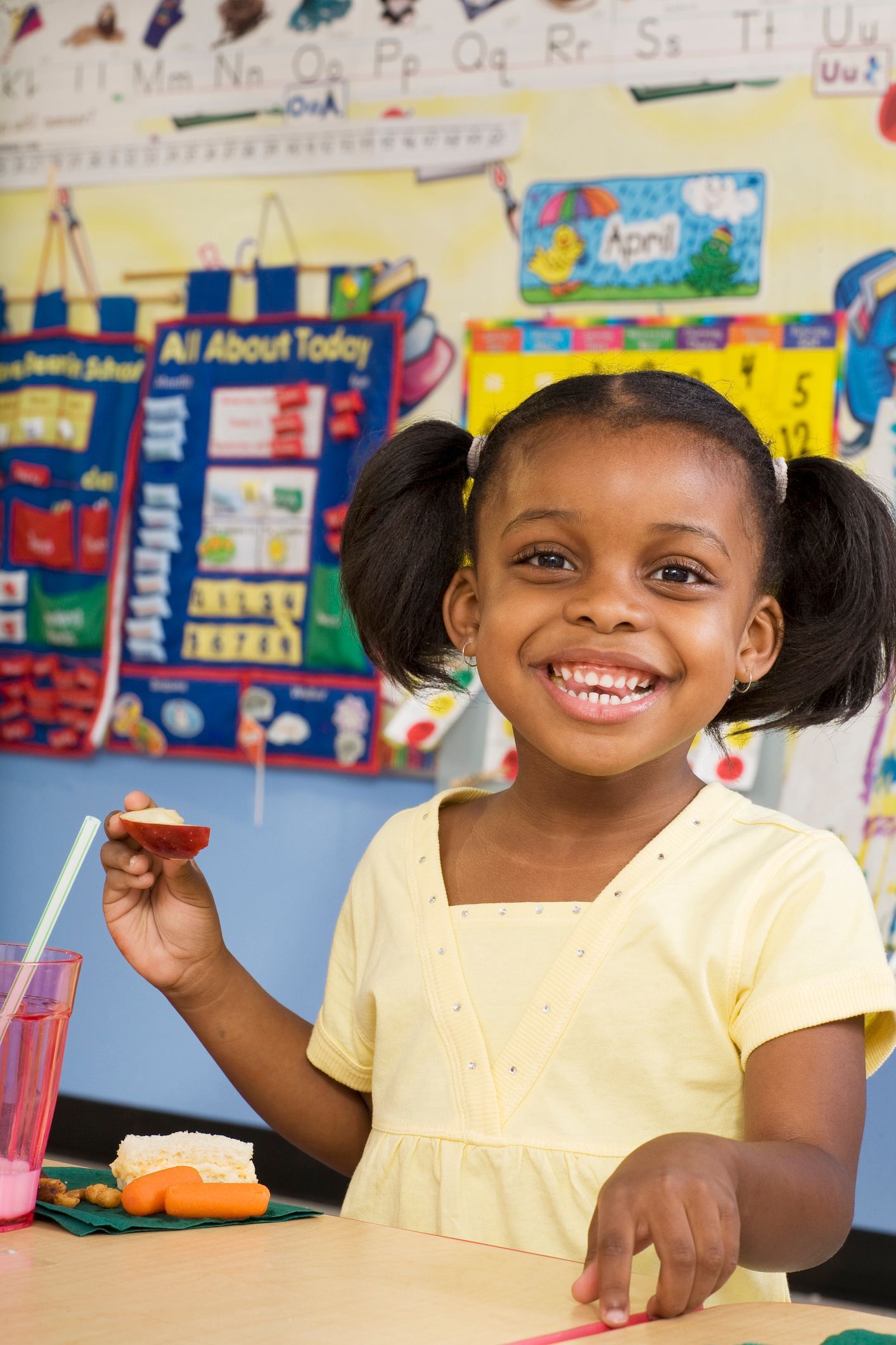 Small 4-year-old girl smiling at the camera in Pre-K Small 4-year-old girl smiling at the camera in Pre-K