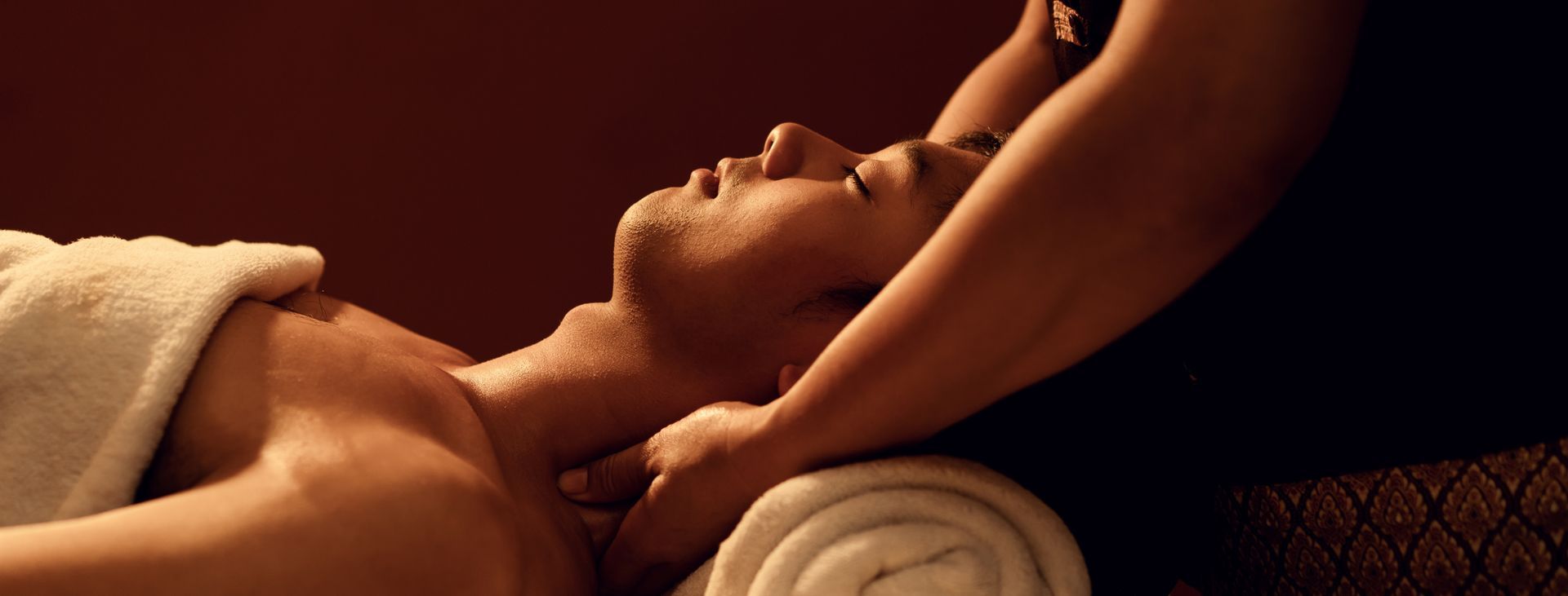 A woman is giving a man a massage in a spa.
