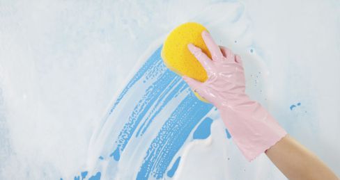 One of our cleaning contractors cleaning a window in Brisbane