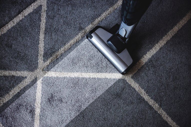 Vacuum Cleaner Cleaning a Gray Patterned Rug — Les's Eco Carpet Cleaning in Mullumbimby, NSW