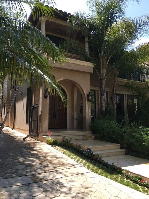 A large house with palm trees in front of it