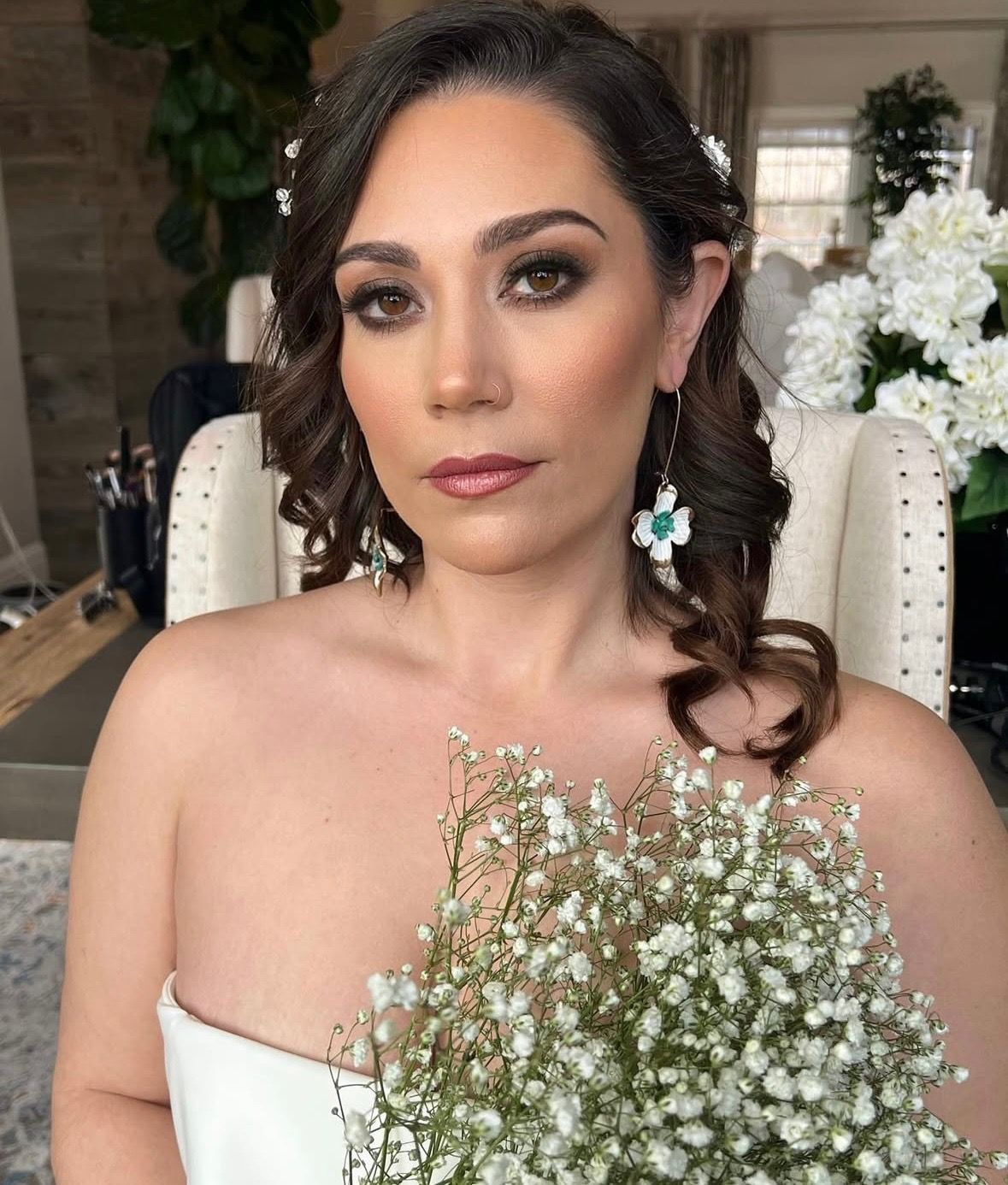 Woman having lipstick applied by a makeup artist. Close-up, indoors.