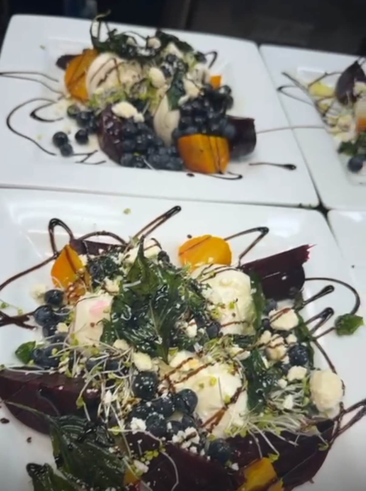 A white plate topped with a salad of fruit and vegetables.