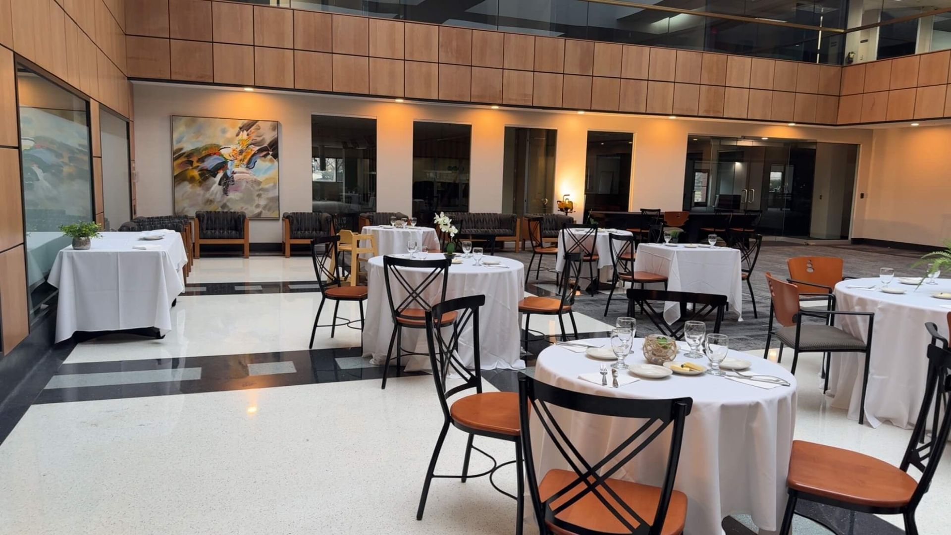 A large room with tables and chairs in it.