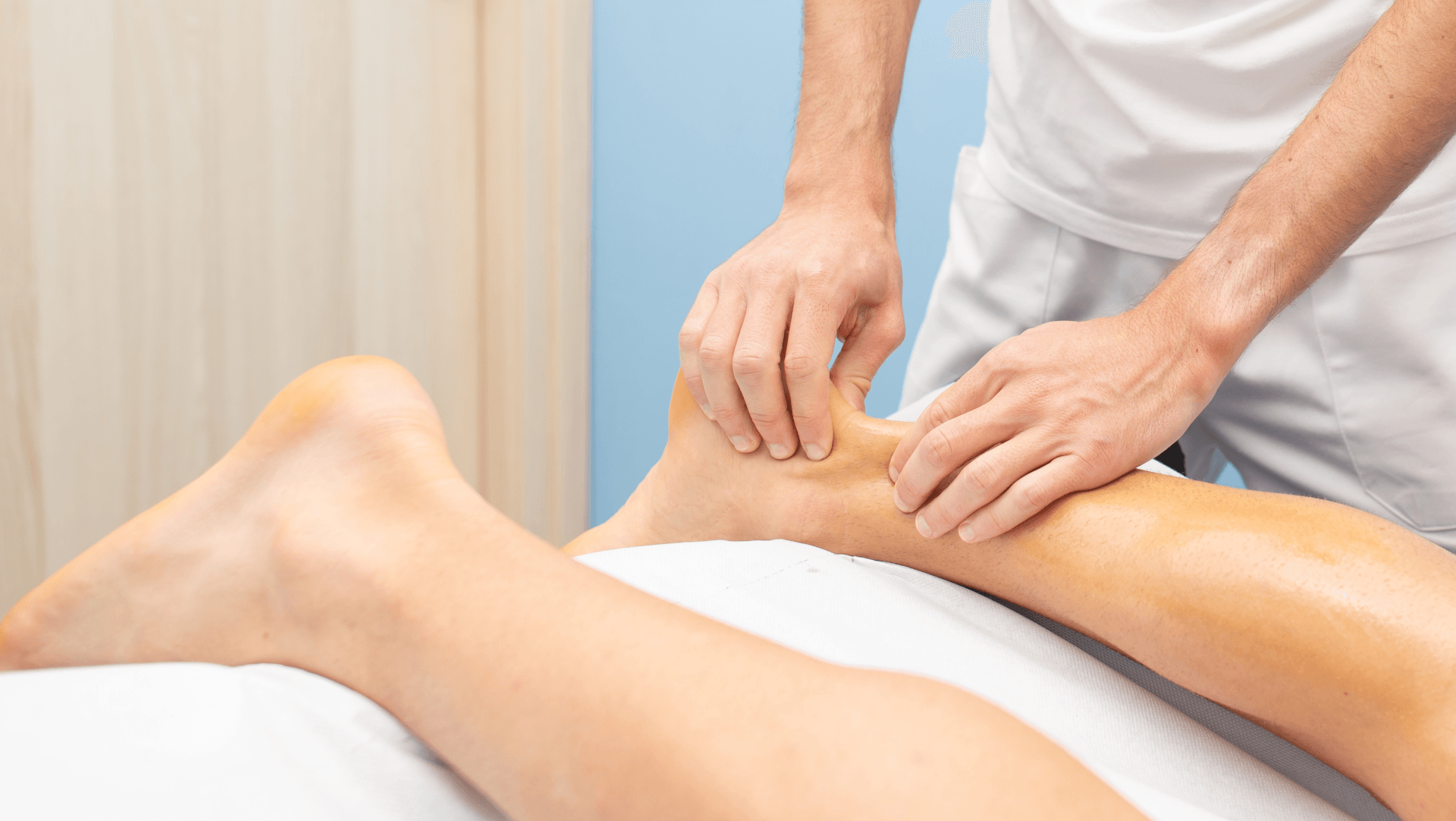 A person is getting a massage on their ankle.