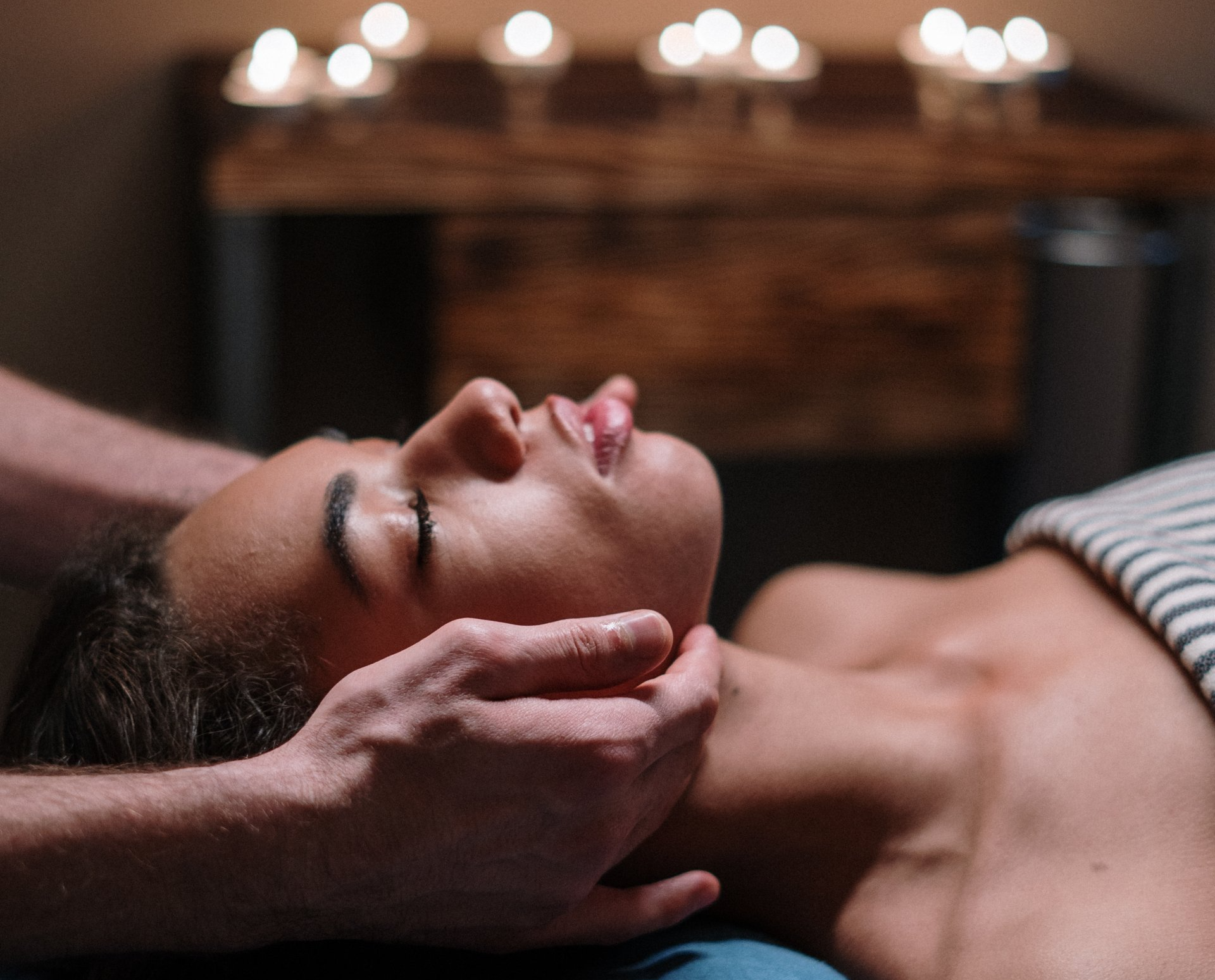 A woman is getting a head massage in a spa.