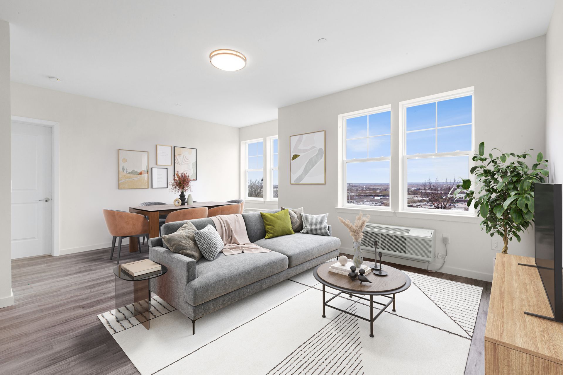 a living room with a couch , coffee table , and television .