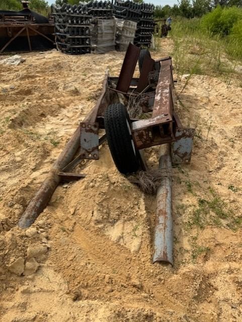 A tire is laying on the ground next to a piece of metal.
