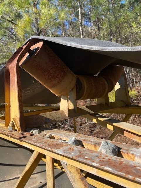 A conveyor belt is sitting on top of a wooden table.