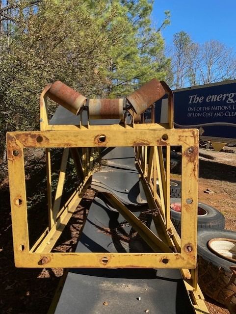 A conveyor belt is sitting in front of a sign that says the energy