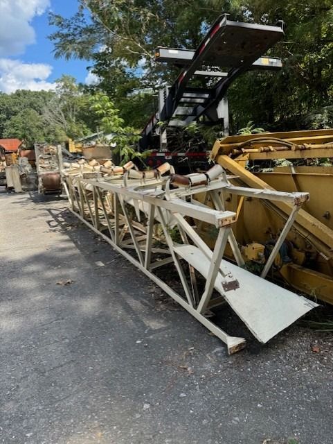 A large metal structure is sitting on the side of the road.