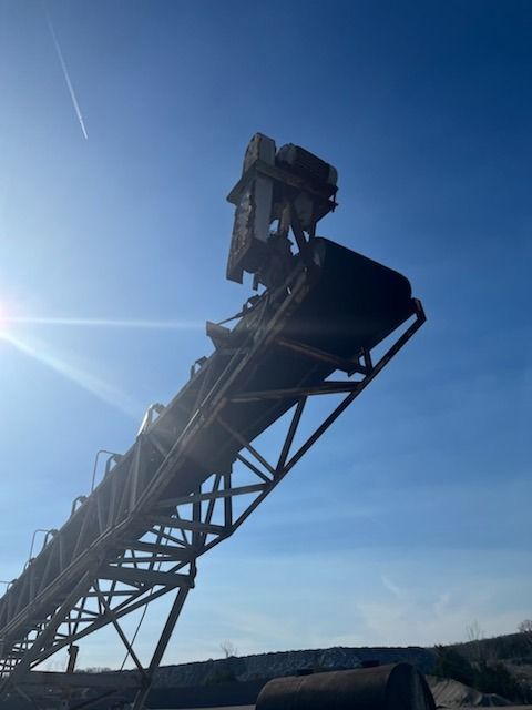 A conveyor belt is going up against a blue sky