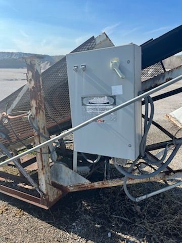 A white box is sitting on top of a metal structure.