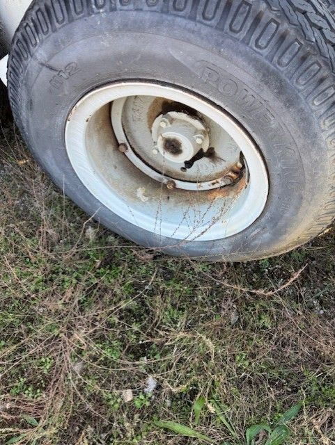 A close up of a tire on a grassy field