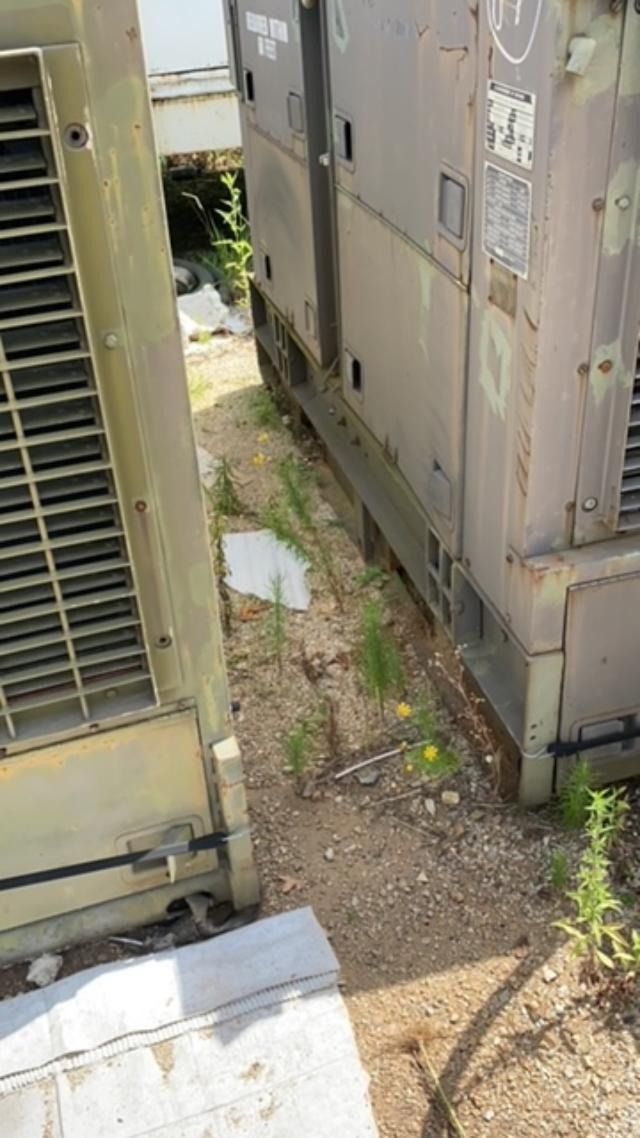 A couple of air conditioners are sitting next to each other on the side of a building.