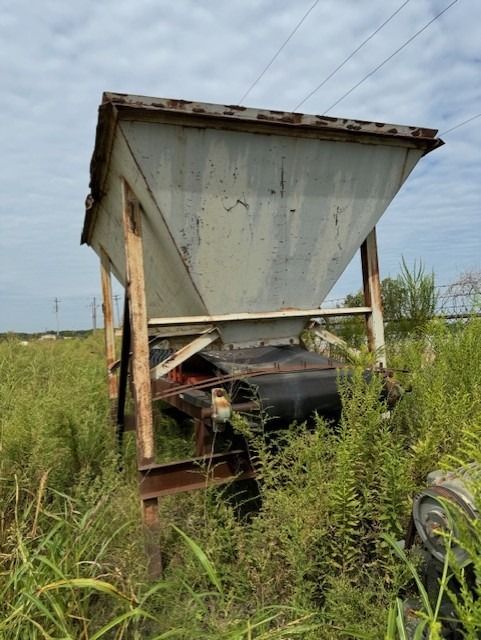 A large container is sitting in the middle of a grassy field