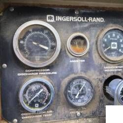 A close up of a compressor control panel with a bunch of gauges on it.