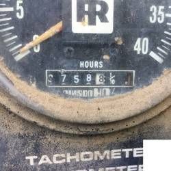 A close up of a tachometer on a vehicle.