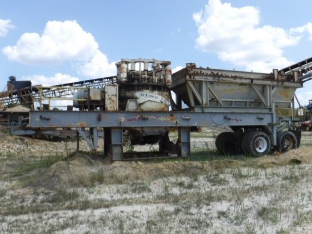 A large machine is sitting in the middle of a field.