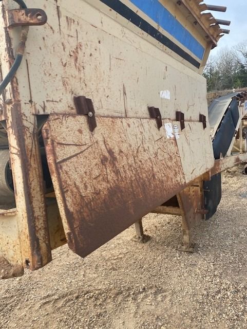 A rusty piece of metal is sitting in the dirt