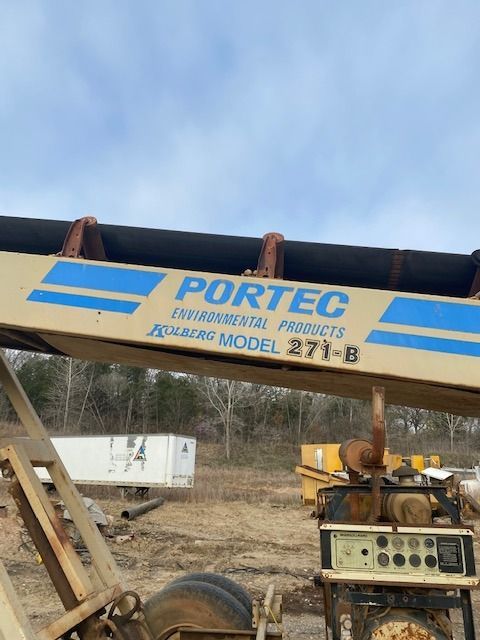 A portec crane is sitting in a dirt field