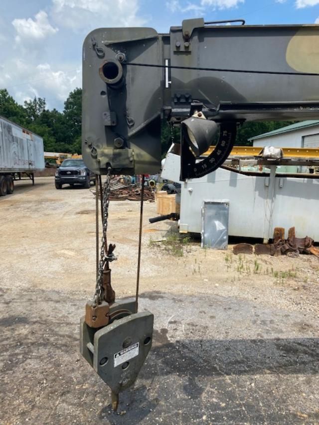 A large crane is sitting in a parking lot.