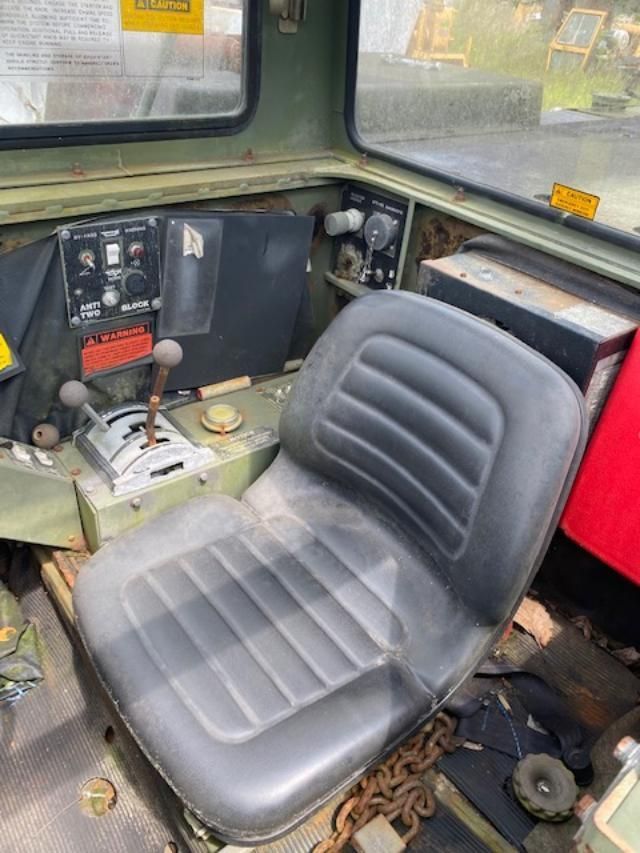 A black seat is sitting in the driver 's seat of a vehicle.