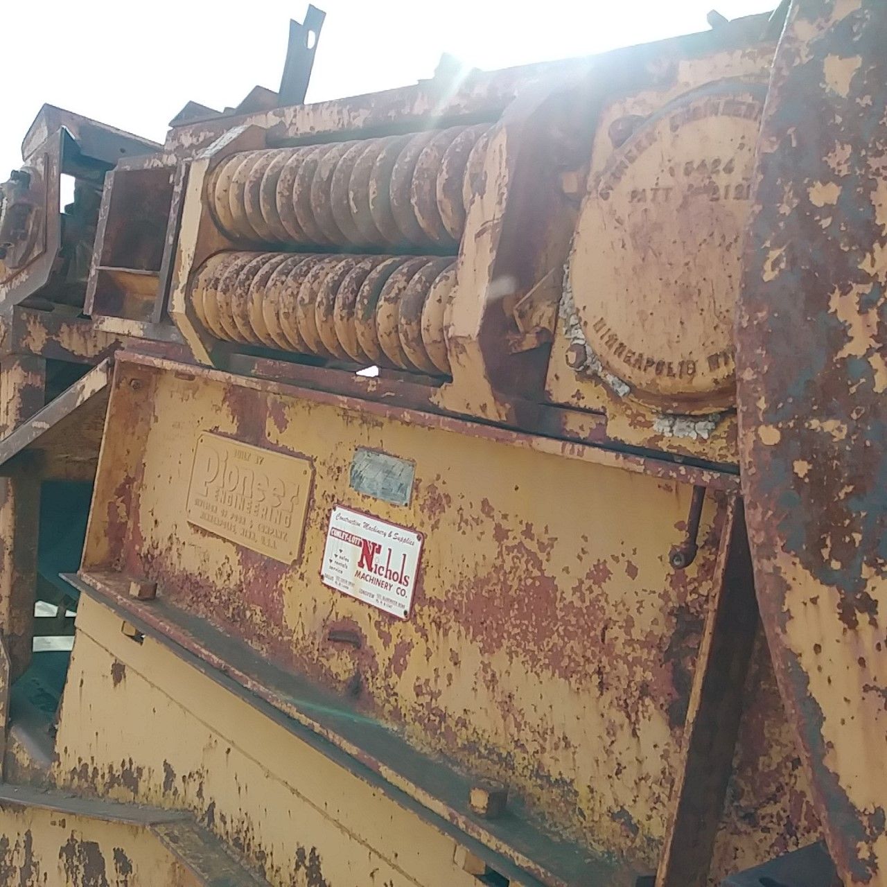 A rusty machine with a sticker on it that says j.l.