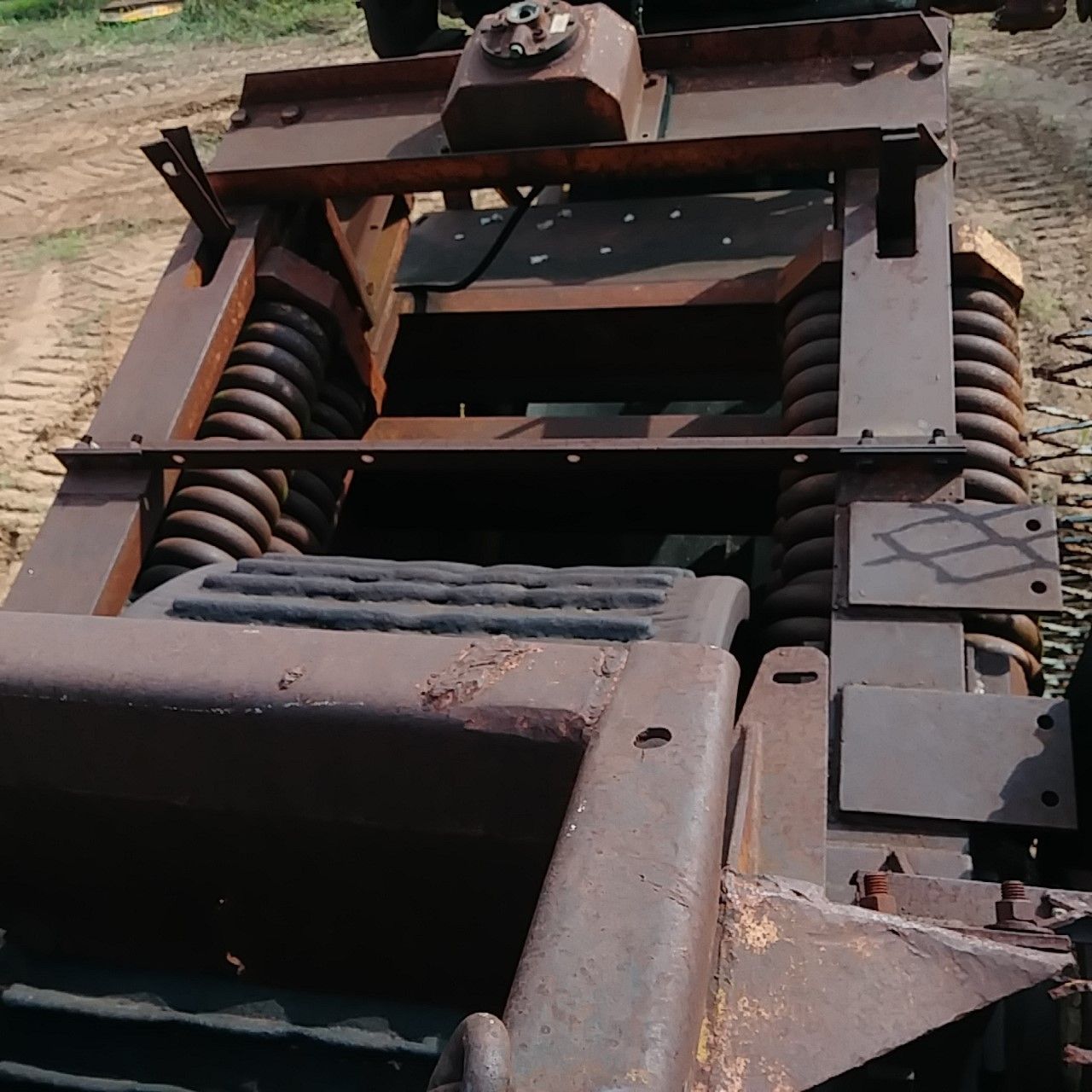 A very old rusty vehicle with a few shocks on it