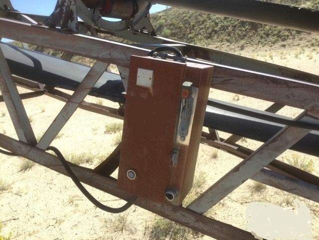 A brown box is attached to a metal structure