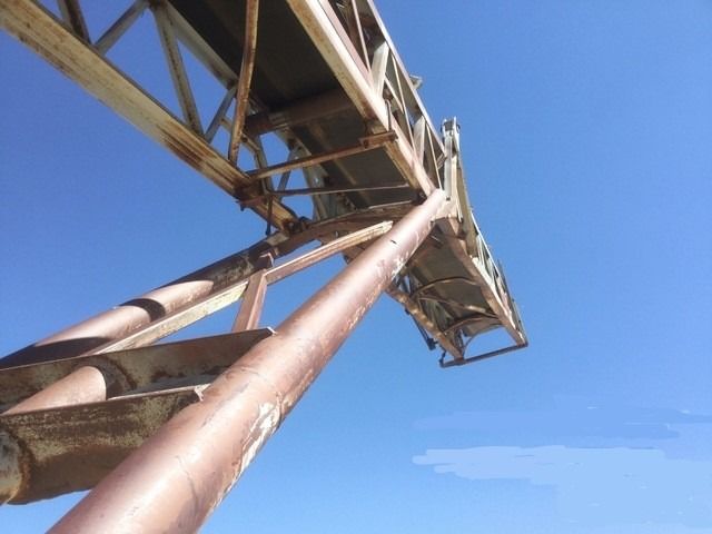 Looking up at a bridge with a blue sky in the background