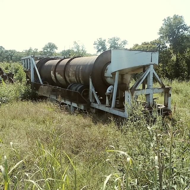 A large machine is sitting in the middle of a grassy field