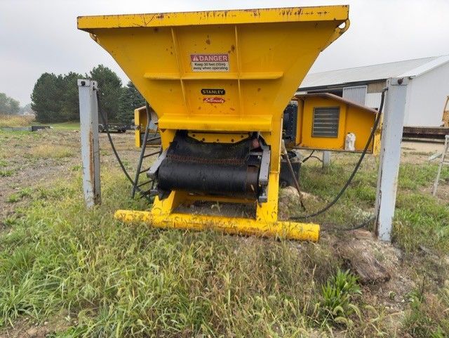 A yellow machine with a danger sign on it