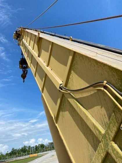 A yellow crane with a blue sky in the background