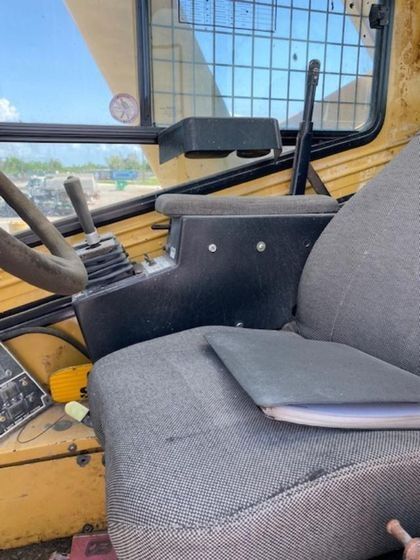 A close up of a seat in a vehicle with a book on it